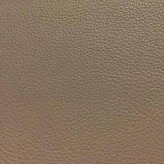 Leather sample S5005, tan color, fine pebble grain texture, diffused lighting, Rugiano indoor rug collection material closeup.